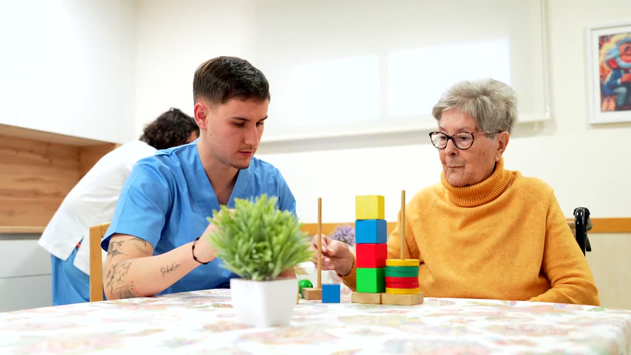 Caregiver assisting senior woman with cognitive game