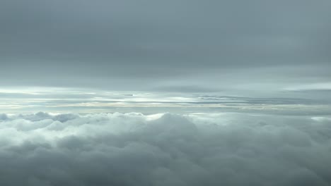 cloudscape pov from an airplane cabin flying across a clouded winter sky plenty of clouds