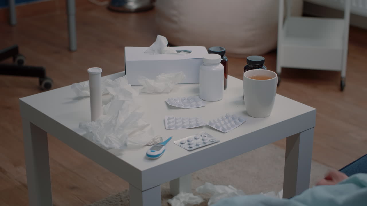 Close up of hand holding tablets of capsules for treatment