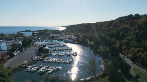 drone shot of a park that looks like an island with boats near a forest on a clear sunny day