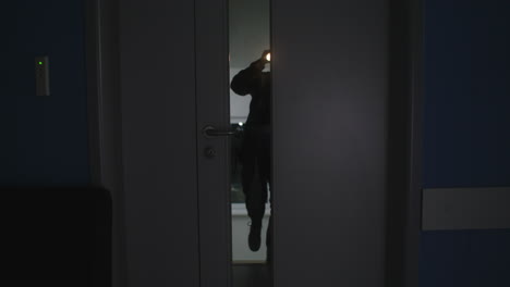 Man opening door at night