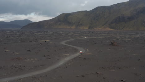 Drone-view-cars-driving-dirt-road-in-icelandic-highlands-exploring.-Drone-view-on-offroad-vehicle-on-desert-road-travelling-in-Iceland.-Adventure-and-exploration