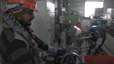 indian working class man control cnc mechanical precision machine, skilled professional technician in metallurgic manufactory factory