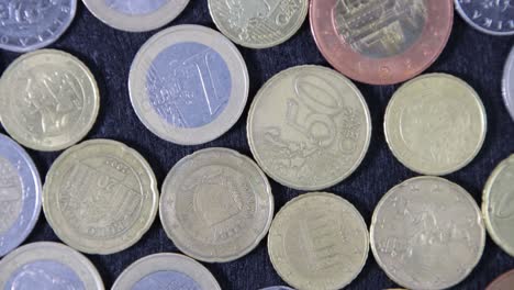 a pattern of coins on a black cloth on a turntable, top view, close-up.