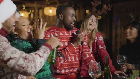 Medium-Shot-of-Small-Group-of-Friends-Singing-In-Karaoke-Bar