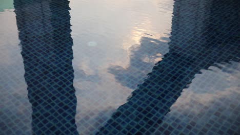 Swimming-pool-ripples-with-reflections-from-the-sunlight-in-Bangkok,-Thailand