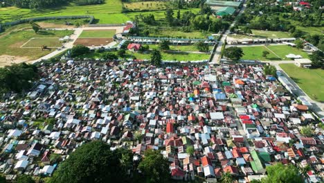 aerial view of a local cemetery revealing city and sea lane, philippines