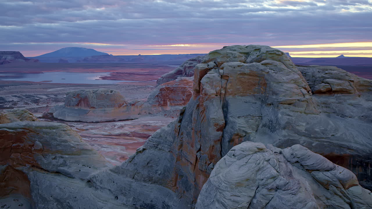 The sweeping aerial footage unveils the stunning rock formations and desert textures of Glen Canyon.