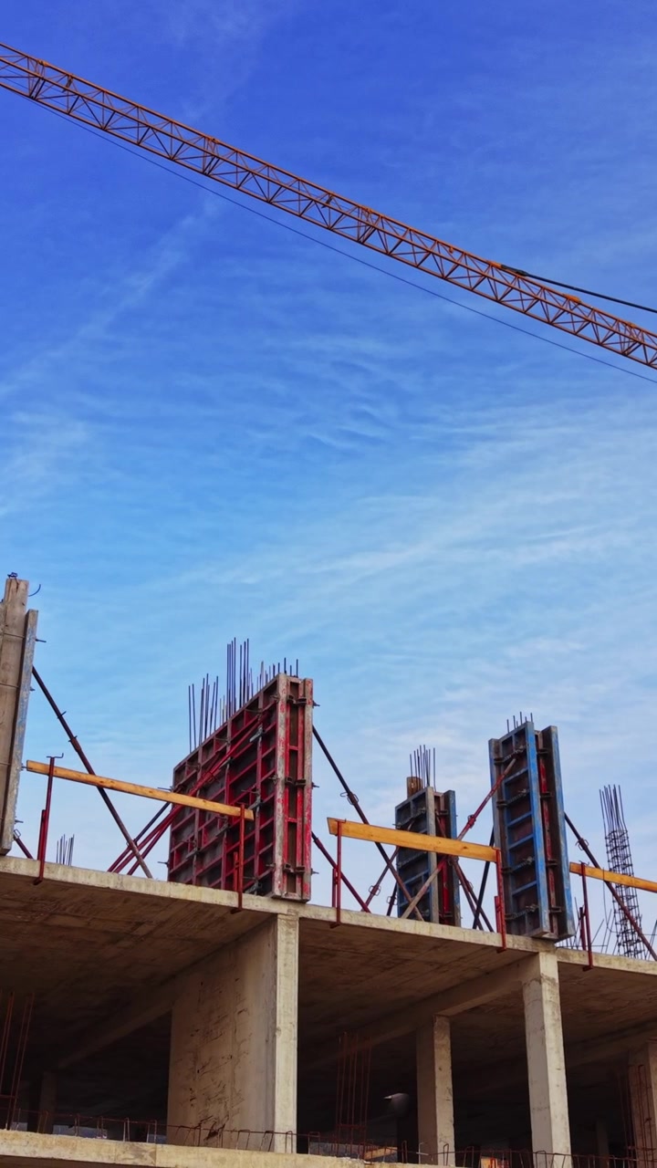 Construction site aerial view showcasing cranes and building framework