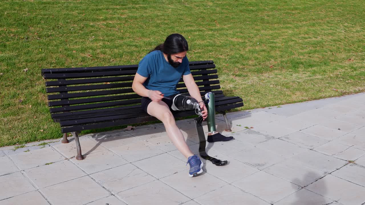 Man with Prosthetic Leg on Bench in Park