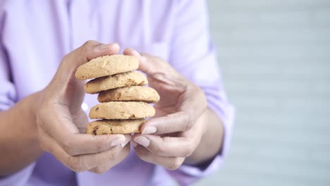 person holding a stack of cookies