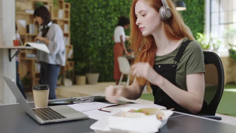 mujer, computadora portátil y cuaderno en la mesa
