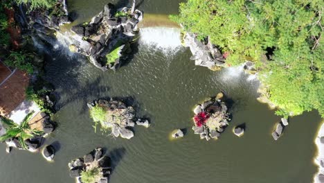 An-aerial-view-directly-above-man-made-waterfalls-at-the-entrance-of-an-apartment-complex-in-Lauderdale-Lakes,-Florida