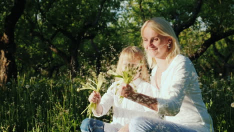 Mom-And-Daughter-Are-Playing-With-Dandelions-Have-A-Good-Time-Together-Slow-Motion-Video