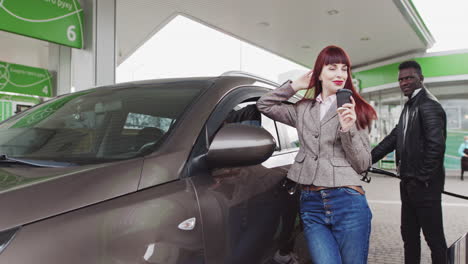 woman and man at a gas station