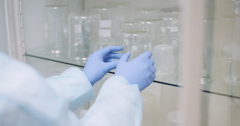 Scientist-Looking-For-Flask-At-Laboratory-1