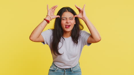 cheerful funny bully indian woman showing tongue making silly faces, fooling around, joking, teasing