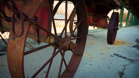 Old-vintage-rusty-cart-wheel-been-tied-into-the-metal-wall,-they-was-used-in-the-Train-station-in-Bowling-Green-in-the-old-day