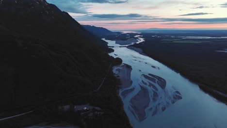 dramatic aerial view of glacier flowing from the mountains in anchorage, alaska