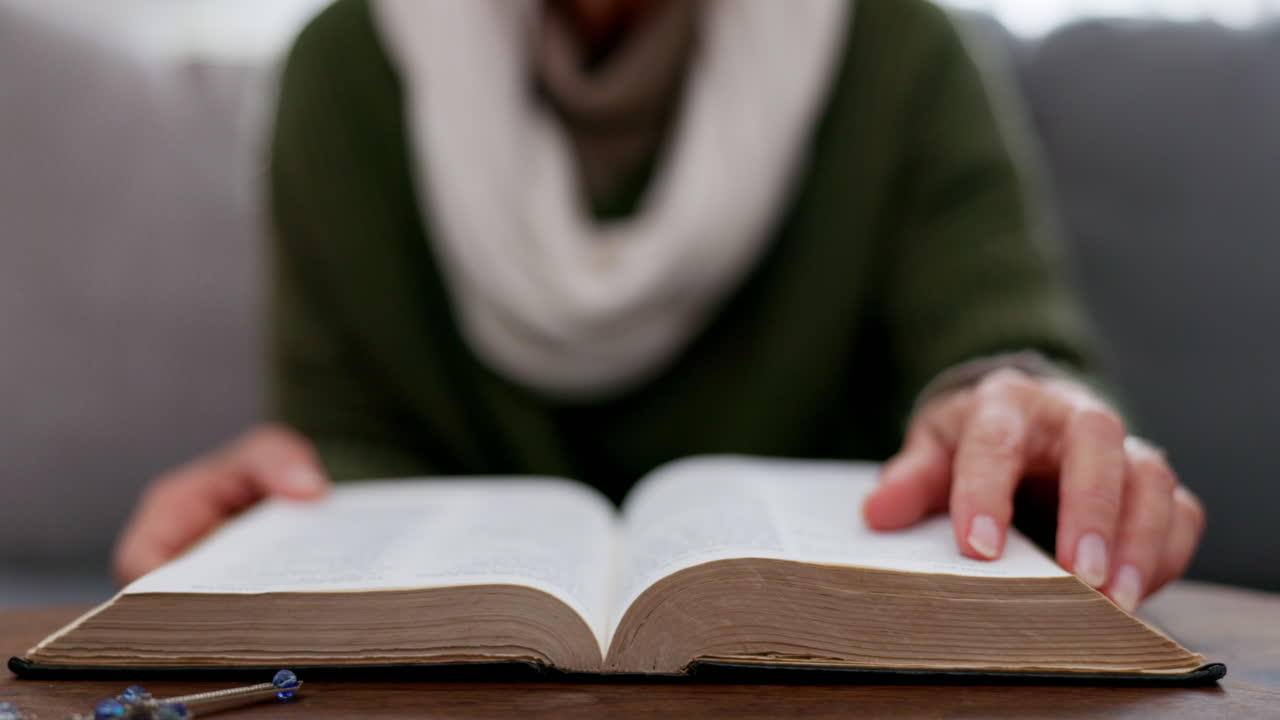 Hands, reading and a book on a table at home