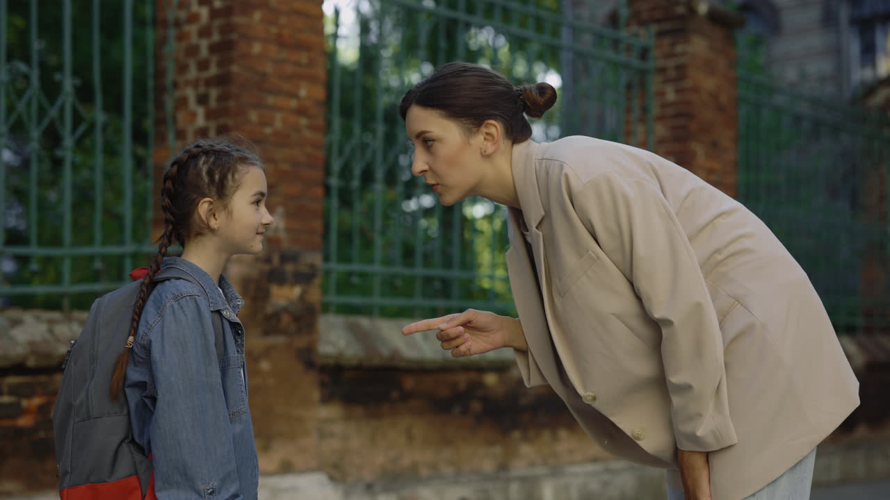 Mother and Daughter Arguing Outside School