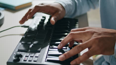 closeup equalizer keyboard man hands touching at home closeup. dj arms mixing