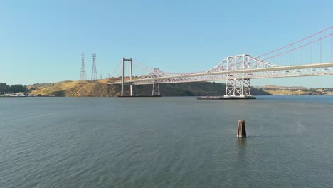 footage captures the alfred zampa memorial bridge spanning across the carquinez strait, as seen from the crockett shoreline under warm california skies