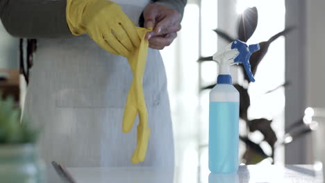 person, hands and gloves in housekeeping