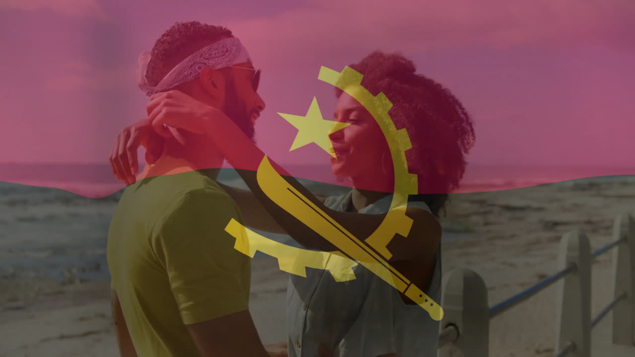 Embracing couple on beach with Angola flag animation in background