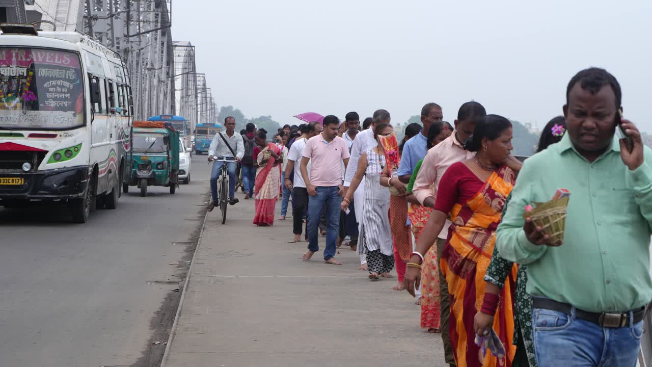 People Walking on a Bridge in India
