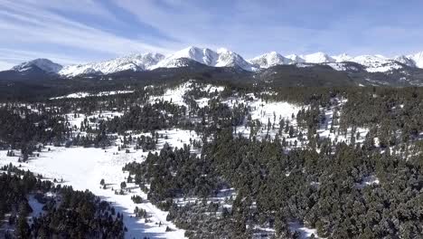 Camera-dolly's-in-above-the-trees-and-mountains