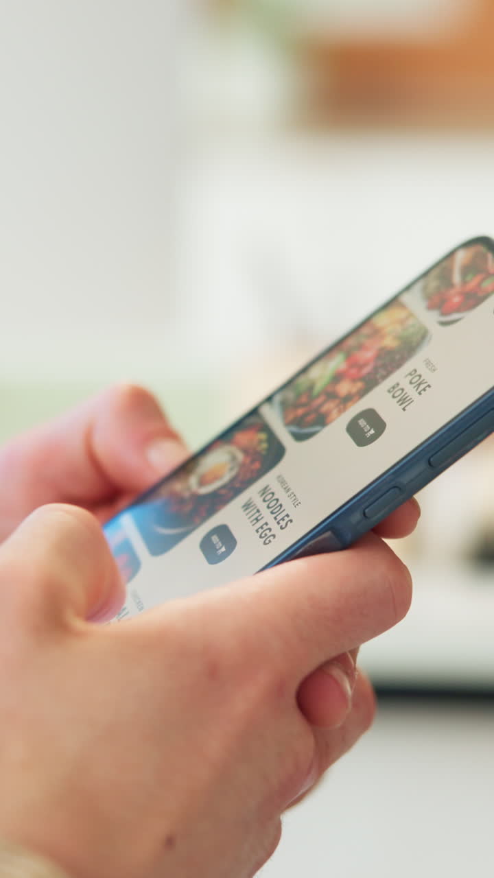 Close-Up of Hands Scrolling Through Food Delivery App on Smartphone