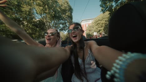 women enjoying a road trip in a convertible