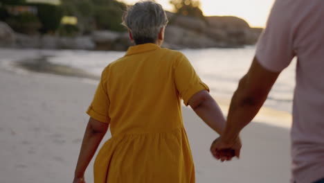 Happy-woman,-walking-and-holding-hands-at-beach