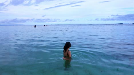 crsytal clear beach with female tourist in gunung payung bali indonesia