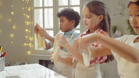 Children-Stretching-Dough-at-Cooking-Class