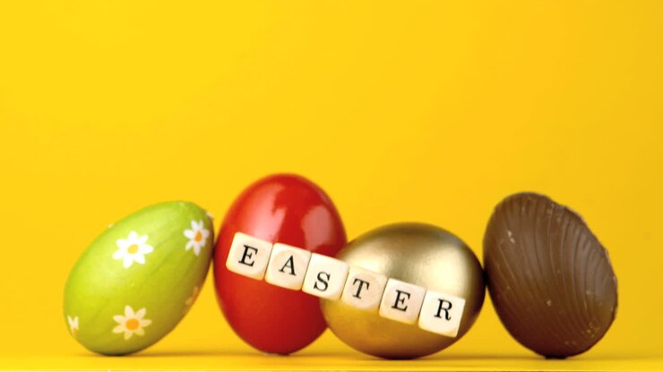 Dice spelling out easter falling in front of four eggs