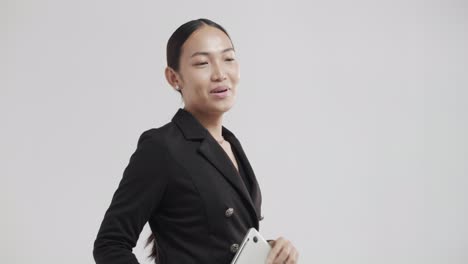 young asian woman in business attire is excited and joyful during an online meeting