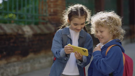 two children looking at a phone