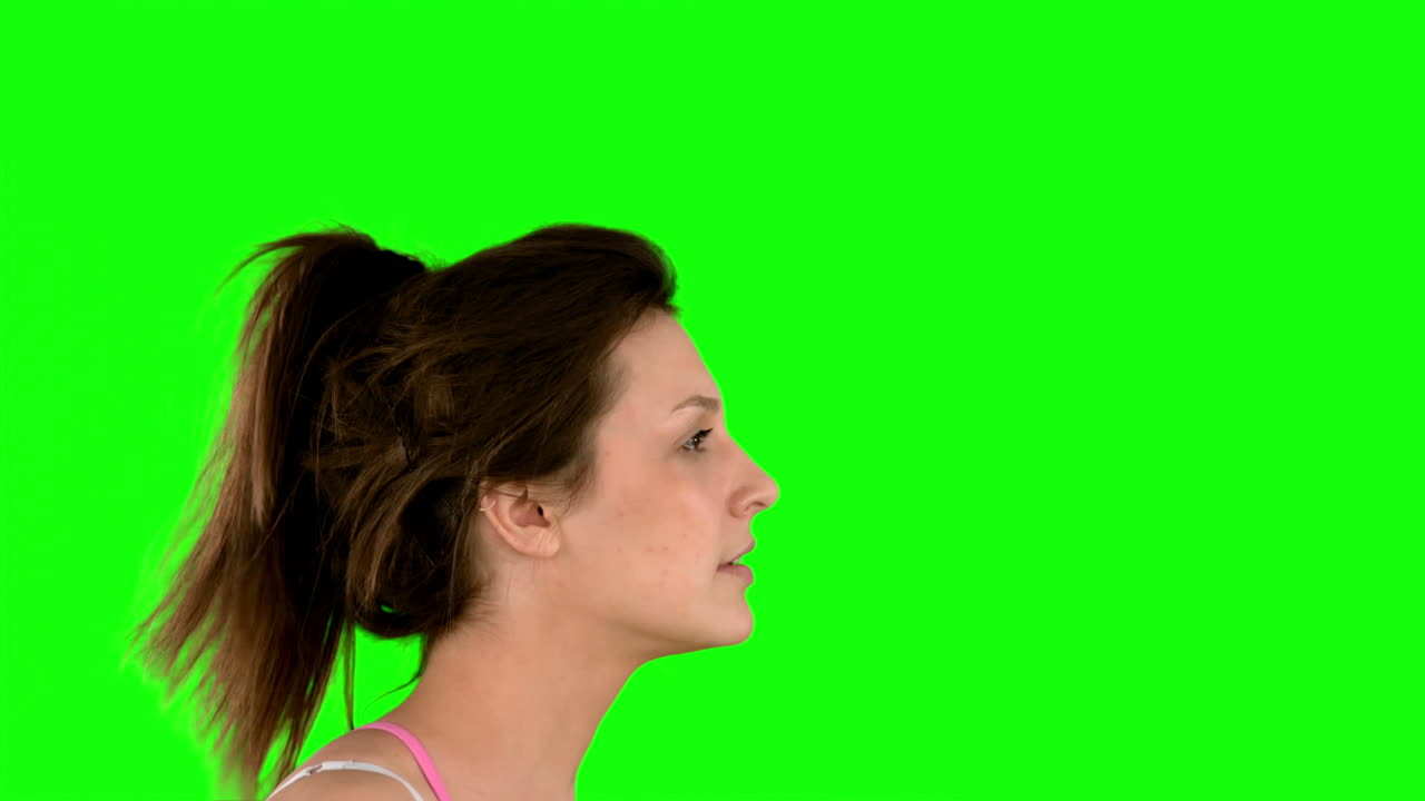 Fit woman jogging on green screen