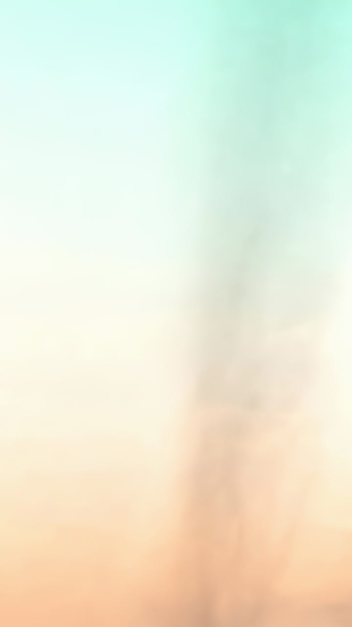 Vertical video: Drifting focus causing cam filming pastel gradient in closeup, showing faint streak