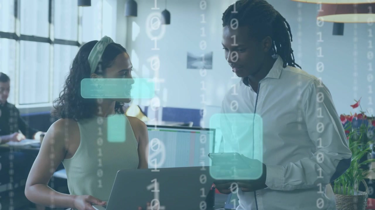 Vertical video: Diverse team holding laptop and phone woman gesturing man leaning discussing HUD