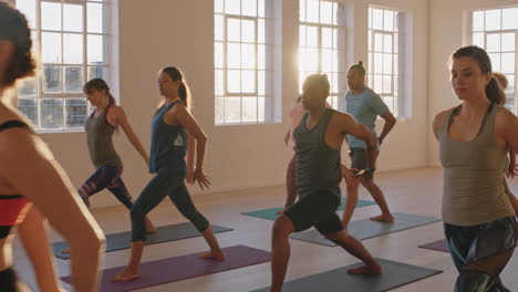 yoga class of young healthy people practicing poses stretching body enjoying exercising in fitness studio with instructor at sunrise