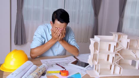 young architect man tried with an architectural project