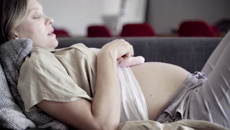 side view of young woman playing with babys booties