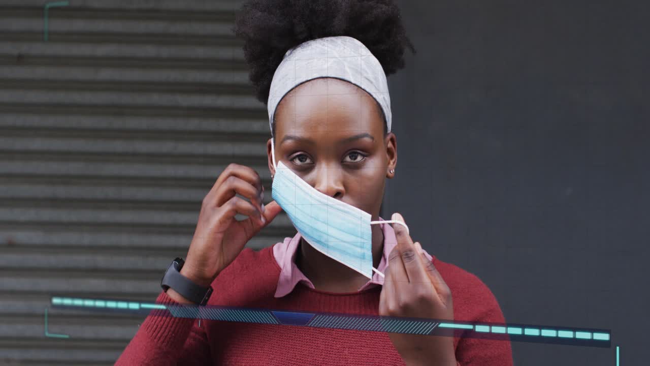 Woman by corrugated shutter responding to viral HUD alert, donning blue surgical mask for health