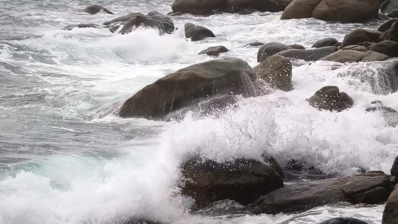 Waves Crashing Against Rocks on a Stormy Coastline