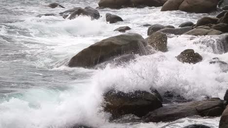 waves crashing against rocks on a stormy coastline