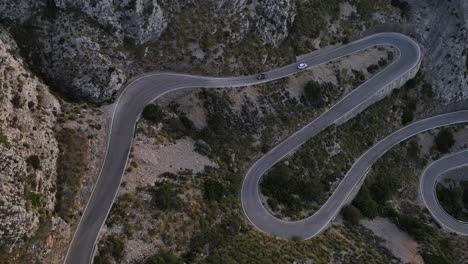 Aerial-top-shot-of-cars-passing-through-the-snake-road-Sa-Calobra-in-Mallorca