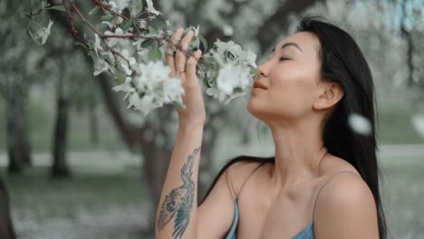 woman enjoying spring blossoms